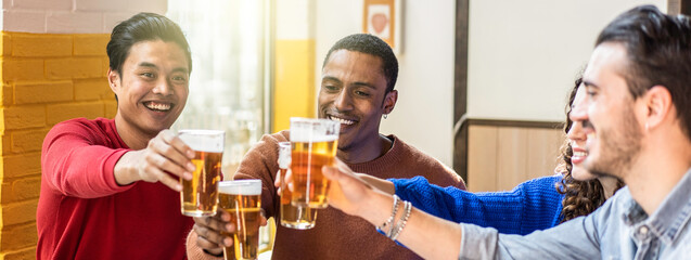 Horizontal banner or header with happy friends drinking beer at pub bar - Multiethnic lifestyle concept with genuine people enjoying time together eating and drinking beer at colorful pub hall