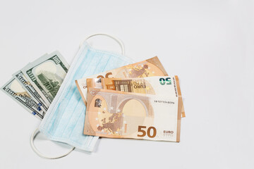 Medical mask and many banknotes of money, medical salary and economy