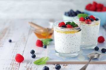 Greek yogurt in glasses with berries and quinoa