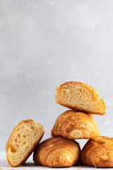 Fresh croissants on a grey background. French breakfast. Copy space