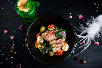 Salad with tuna, cherry tomatoes, olives, quail eggs, lettuce, sesame, microgreens and green lemonade tarragon.