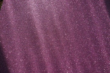 Oblique rays of light on a purple lilac surface. Bokeh, dust particles, reflection magical glow....
