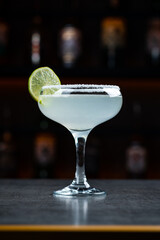 Margarita cocktail with tequila, lime, sugar syrup, salt and ice in a glass.