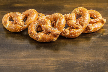food background of pretzels on a wooden surface close up