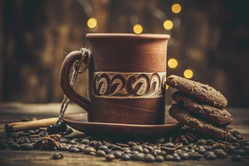 Gordijnen Beautiful mug with coffee and chocolate cookies on a beautiful background, holiday treats © Anton