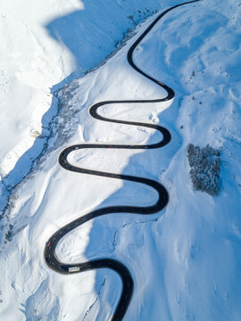 Aerial view of the winding road over the  Julier Pass in Swiss Alps mountain in winter full of snow, Canton Grison, Switzerland