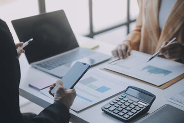 Financial analysts analyze business financial reports on a digital tablet planning investment project during a discussion at a meeting of corporate showing the results of their successful teamwork.