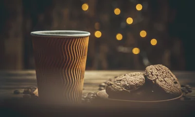 Deurstickers Koffiebar Paper cup with coffee and chocolate cookies on a beautiful background, holiday treats