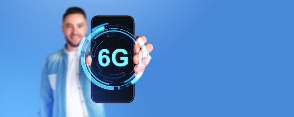 Man holding smartphone with 6G glowing icon connection on screen