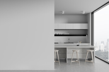 White kitchen with island and blank wall