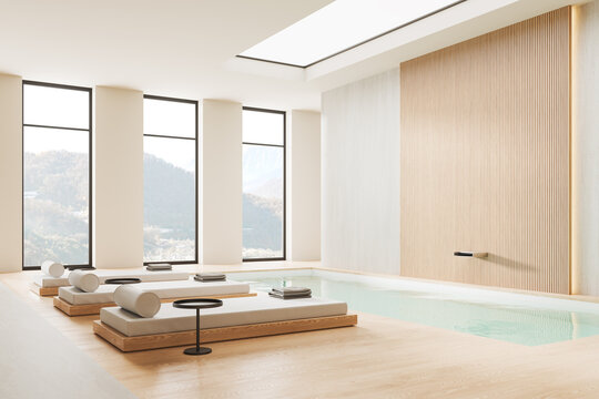 White and beige spa interior with loungers and panoramic window