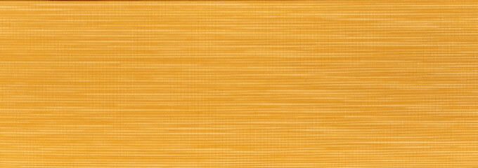  An orange textured background made of fabric material.