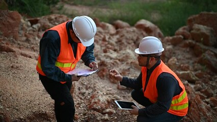 Geologist surveying mine,Explorers collect soil samples to look for minerals.