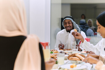A traditional and diverse Muslim family comes together to share a delicious iftar meal during the sacred month of Ramadan, embodying the essence of familial joy, cultural richness, and spiritual unity