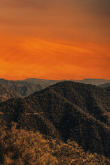 Mountain landscape at sunset. View of big mountains at sunset with bright orange sky