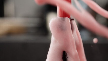 closeup open a bottle of berry soft drink which is over pressured and make a fountain