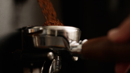 closeup of fresh ground coffee fall in portafilter