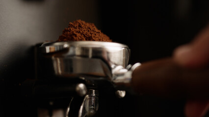 closeup of fresh ground coffee fall in portafilter