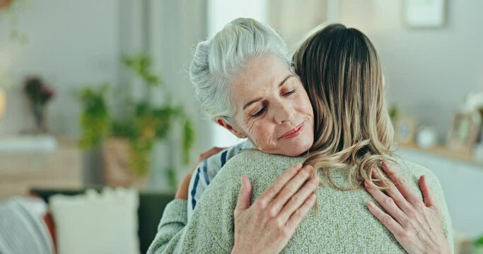 Love, comfort and woman hug senior mother in a living room with compassion, trust and empathy in their home. Mama, support and female person embrace elderly parent in a lounge with solidarity or care