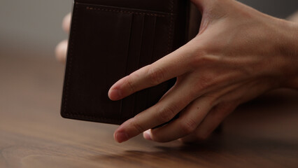 man check leather wallet on wood table