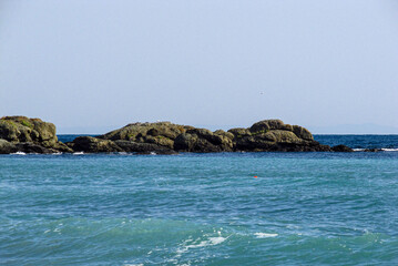 Fototapeta na wymiar Sea, rocks and empty blue sky