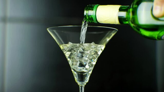 Bartender mixing aperitif alcohol vermouth ice cube