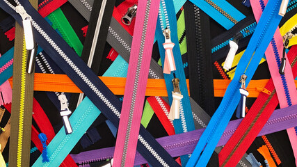 Multicolored Zippers or Zip Fasteners used for binding fabric or textile. Colorful Clasp Lockers...