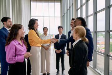 Commitment with hand shake by business team in seminar office room and other people crap the hand...