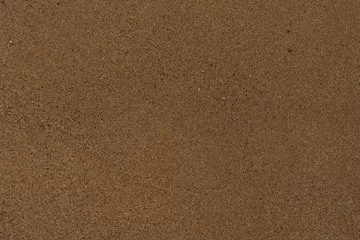 Foto op Plexiglas Texture of wet sand on a beach top view © GCapture