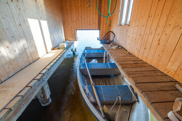 Close-up view of wooden boat in wooden parking house. Sweden.