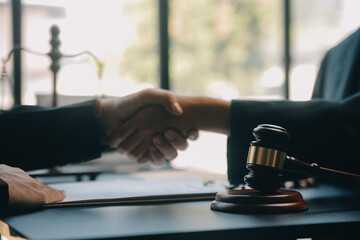 Justice and law concept.Male judge in a courtroom with the gavel, working with, computer and...