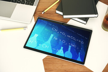 Creative chemistry illustration on modern digital tablet display, science and research concept. Top view. 3D Rendering