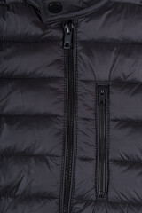 Closeup of black zipper on a wintry black jacket.Zipper winter jacket, close-up.Quilted jacket.