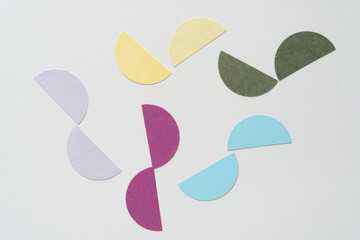cut paper circle halves on blank paper