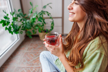 Woman enjoying leisure time at home drinking hot tea
