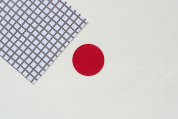 red circle and paper with grid on blank paper