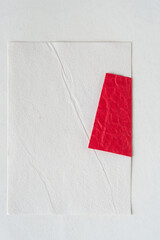 blank paper with wrinkle and folded red paper with wrinkles on white