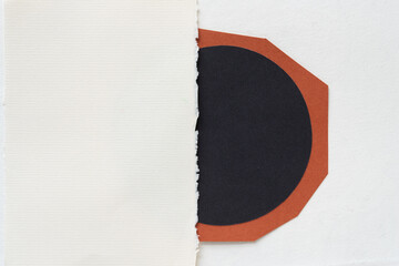 stationery sheet with deckle edge over grungy black paper semi circle sticker on brown paper 