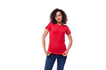 young positive curly brunette woman dressed in a red t-shirt in corporate color