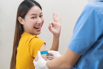Healthcare of Covid-19, corona anti virus vaccination, happy asian young woman hand showing ok at...