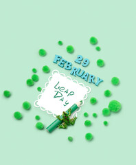 February 29 date, Leap Day card  and Frog toy on green abstract background. leap day in leap year...