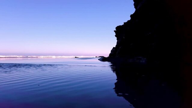Untransparent video clip of Las Catedrales beach showing the crystal clear water with a natural mirror effect where you can see the waves that characterize this emblematic tourist place in Galicia.