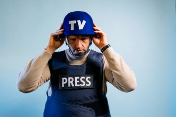 Reporter with bulletproof vest in the studio.