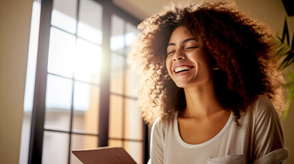 Laughing African American woman communicating on social networks using a tablet