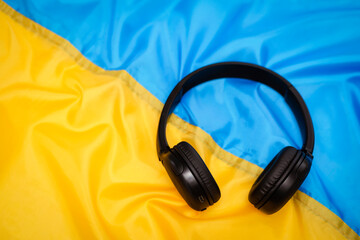 Listen and Speak Ukrainian Language. Headphones on Blue Yellow Ukraine Flag Background. Audio Book,...