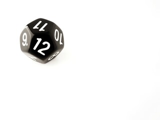 D12 black 12 sided dice isolated on white and copy space. RPG dice. Dodecahedron DND dice