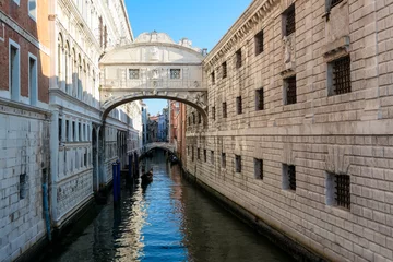 Papier Peint photo Pont des Soupirs Gondola ride on the Rio di Palazzo under the Bridge of Sighs in Venice, Veneto, Northern Italy, Europe. Last thing criminals saw before the went to jail. Historical building. Urban tourism