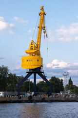 Yellow portal crane on blue base stands in the harbor of Kaliningrad