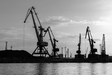 Harbour cranes at the sea port. Silhouette photo