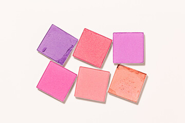 Pink purple colored eyeshadows powder close-up texture, swatches of eye shadow powder or blusher, top view pattern, face makeup powder, woman cosmetics and beauty product, minimal style